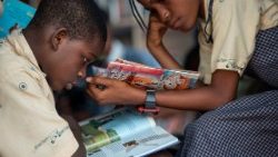 A boy and a girl read books at a library in Lagos, Nigeria
