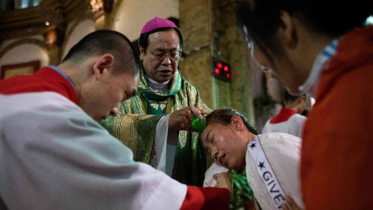Dom Joseph Li Shan batiza fiel na Catedral de Beijing.