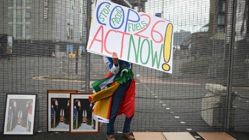 An activist outside the venue in Glasgow where the COP26 UN Climate Change Conference is taking place