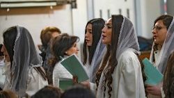 Des femmes syriaques orthodoxes chantent lors de la messe de Noël dans la ville kurde de Qamishli, en Syrie, le 25 décembre 2021. (Delil Souleiman/AFP)
