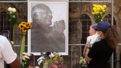 People bring flowers to St. Georges Cathedral, where a Wall of Remembrance for of Desmond Tutu, Nobel Peace Laureate, has been set up