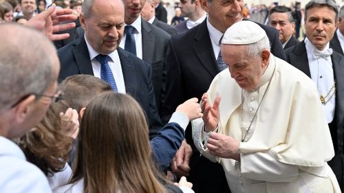 Pope Francis blesses a Rosary belonging to children