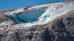 A rescue helicopter flies over the glacier that collapsed on the Marmolada range in the Dolomites