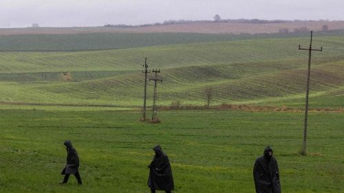 Police investigators are seen during a searching patrol in the fields near the site where a missile strike killed two men in a village in eastern Poland
