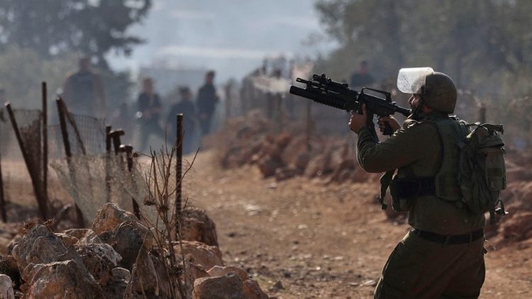 Israeli soldiers clash with Palestinian demonstrators following a protest against the establishment of Israeli outposts