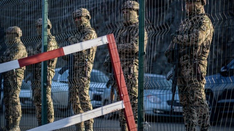 Azerbaijani servicemen stand guard at a checkpoint at the Lachin corridor