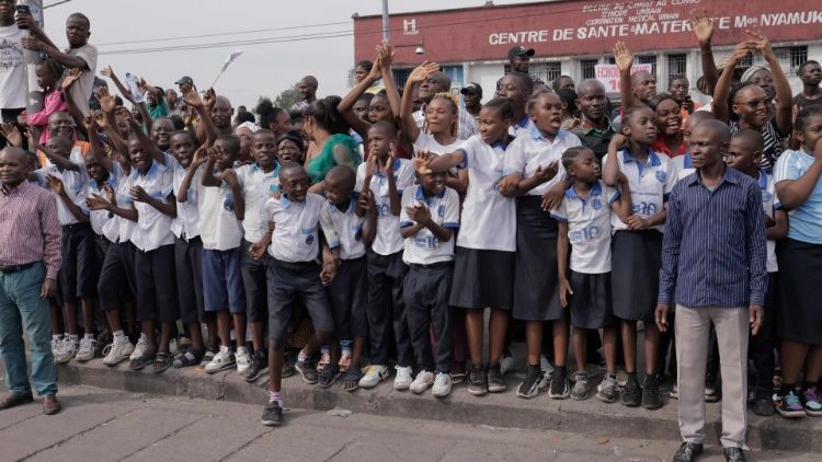 School children in Kinshasa waiting to get a glimpse of Pope Francis.