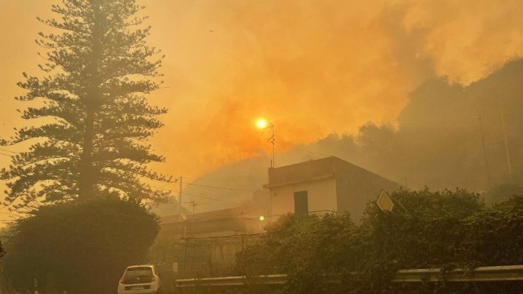 Smoke from a wildfire in Sicily affected by extreme heat