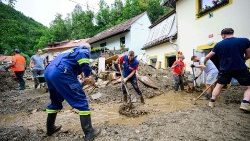 Volunteers help clear rubble from the roads in Slovenia 