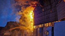 Firefighters battle the blaze at the Caritas Spes warehouse in Lviv on Tuesday night