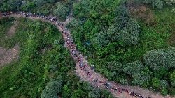 हवाई दृश्य में प्रवासियों को बाजो चिक्विटो गांव के पास जंगल से गुजरते हुए दिखाया गया है, जो पनामा में डेरियन प्रांत का पहला सीमा नियंत्रण है