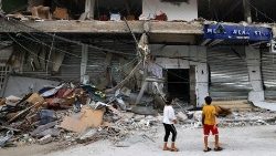 Crianças olham para danos em café em Khan Yunis, no sul da Faixa de Gaza, em 22 de outubro de 2023, durante as batalhas em curso entre Israel e o grupo palestino Hamas. (Foto de Mahmud HAMS/AFP)