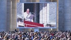 Pope Francis is seen on the television screens in St Peter's Square as he leads the Angelus