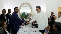 Venezuelan President Maduro shakes had with Guyana's President Ali during a meeting over the territorial dispute around the Essequibo region