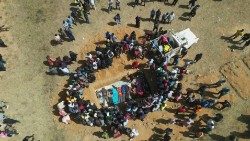 Aerial view of families burying their relatives in a mass grave in Nigeria's Plateau State