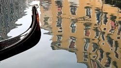 A gondola plies the canals of Venice