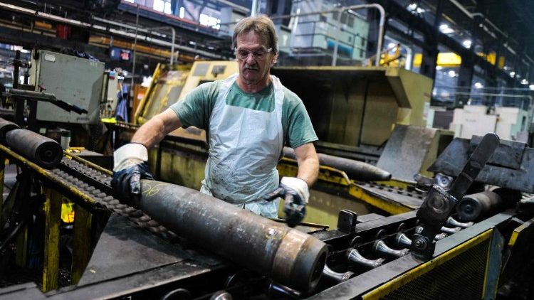An employee handles 155mm caliber shells after being manufactured in Pennsylvania, US