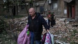 Local residents take their belongings out of damaged buildings after a missile attack, Dnipro