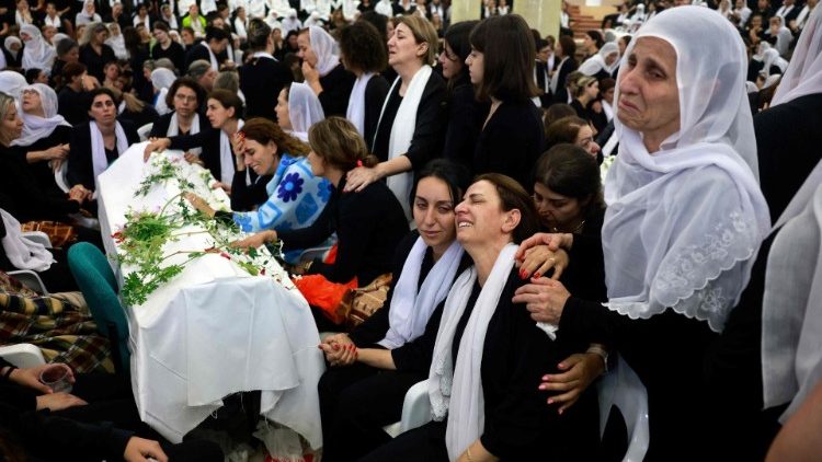 Women mourning at funeral for children killed in playground attack in the Druze town of Majdal Shams in the Israel-occupied Golan Heights.