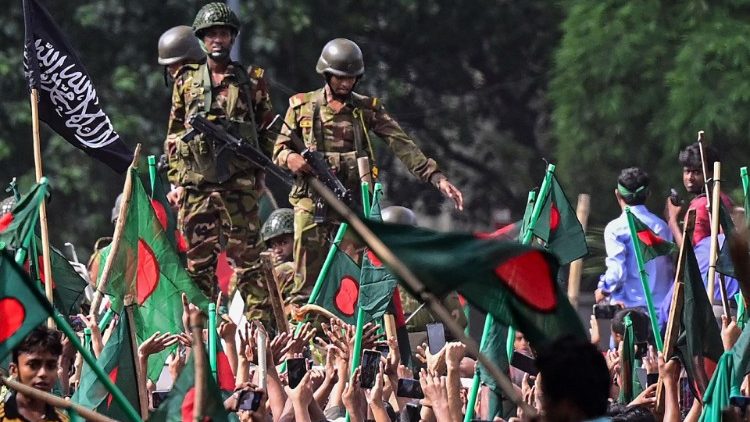 Bangladesh army personnel stand guard as anti-government protesters march to PM Sheikh Hasina's residence