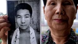 Hideko Hakamada holds a photo of her brother Iwao in 2013