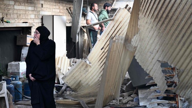  A woman reacts as she checks the damage following a reported Israeli strike in the Mazzeh district of Damascus on November 14, 2024