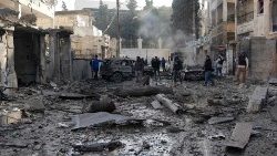 People amid damaged neighborhood following Syrian regime airforce strike on December 1, 2024