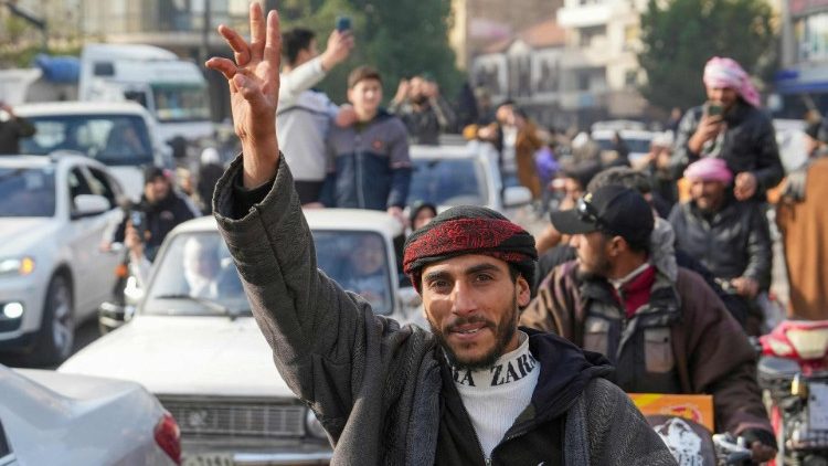 Syrians celebrate in the city of Homs