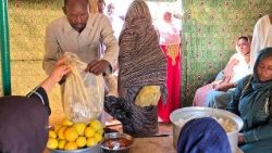 A man collects food from a humanitarian organization in Meroe, Sudan