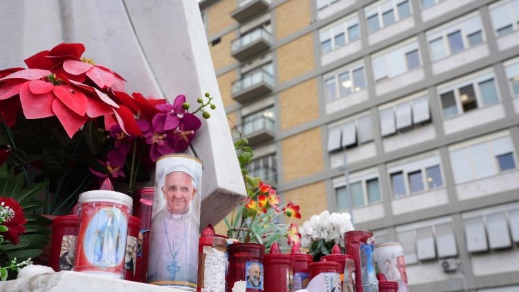 Вернікі ставяць свечкі каля помніка  Яна Паўла II перад шпіталем Джэмэлі ў Рыме, дзе праходзіць лячэнне Францішак