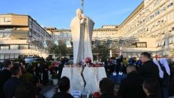 Des dizaines de personnes rassemblées en prière devant l'hôpital Gemelli. 