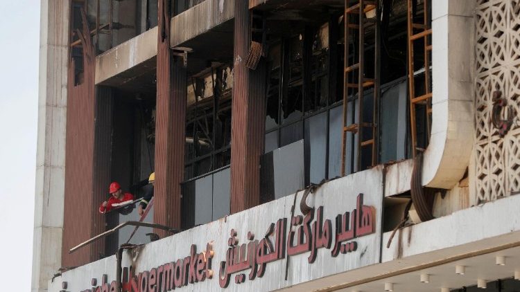 Rrescue teams clear the rubble after the fire in the mall
