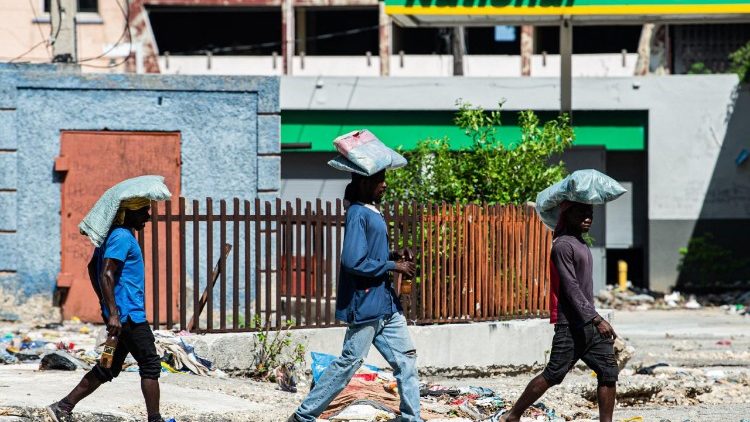 Merchants carry their wares through the city center in Port-au-Prince.