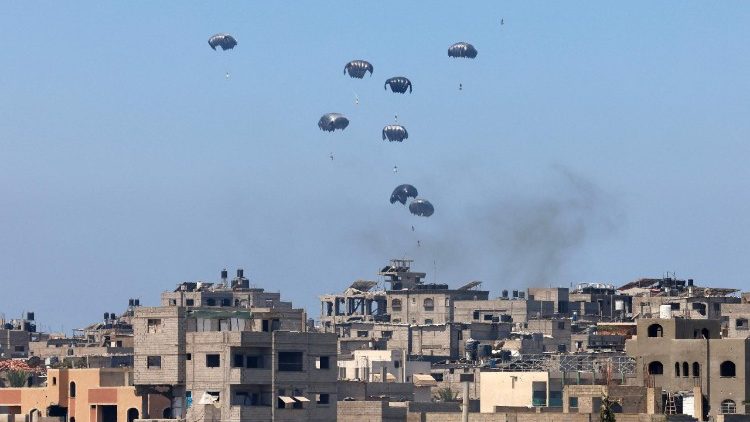 Aid pallets are parachuted after being dropped from a military plane over Nuseirat in the central Gaza Strip during an airdrop mission above the Israel-besieged Palestinian territory on August 4