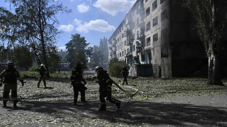 Ukrainian firefigters extinguish fire in a residential building at the site of a Russian drone strike in the town of Bilozerske, Donetsk region