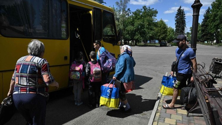 Residents of the town of Bilozerske board a bus to evacuate a strike in Bilozerske, Donetsk region