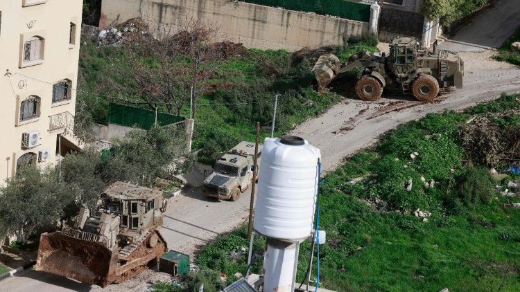 Israeli military bulldozers drive near the Nur Shams Palestinian refugee camp in the West Bank