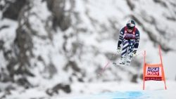 An Olympic athlete competes in a women's downhill race