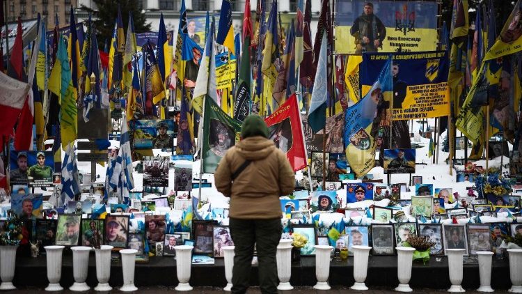 A person stands at a makeshift memorial to fallen Ukrainian and foreign soldiers in Independence Square in Kyiv