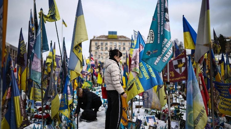 Um morador local visita um memorial improvisado para soldados ucranianos e estrangeiros na Pra&ccedil;a da Independ&ecirc;ncia, em Kiev, em 24 de fevereiro de 2026, no quarto anivers&aacute;rio da invas&atilde;o da Ucr&acirc;nia pela R&uacute;ssia. (Foto de HENRY NICHOLLS / AFP)
