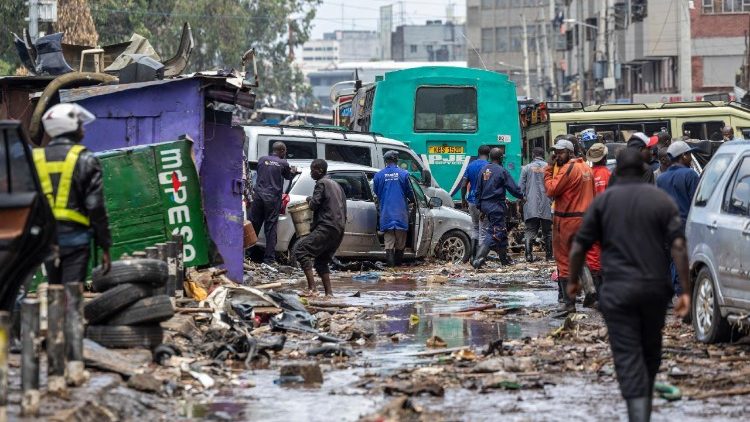 People salvage property from receding flood waters in downtown Nairobi following a night of heavy rainfall that resulting in heavy flooding around Nairobi 