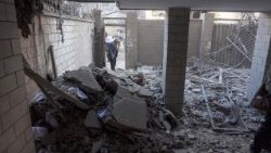 Iranian resident stands outside damaged home 