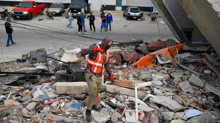 Rescue workers search for victims in Carabelleda, La Guaira State