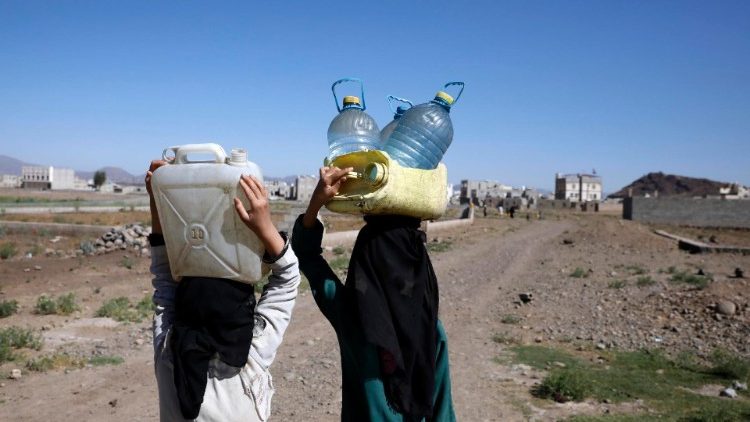 People carry water from a donated water tank