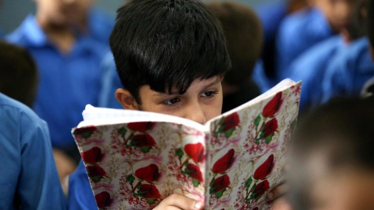 A child reads from a book in Pakistan