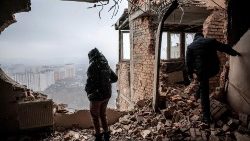 A Kyiv resident inspects her ruined flat after a Russian drone attack