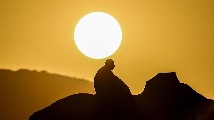 A Muslim pilgrim prays at dawn on Mount Arafat