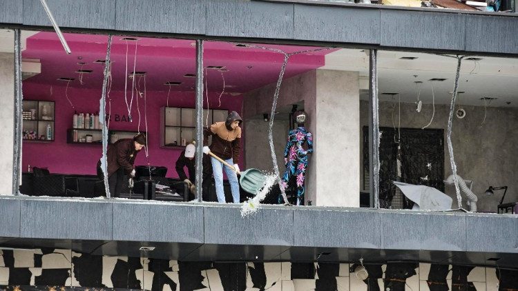 Pessoas limpam os destroços no local de um ataque de bomba planadora russa em uma área residencial em Kharkiv, Ucrânia, 04 de novembro de 2024, em meio à invasão russa. Pelo menos 14 pessoas ficaram feridas como resultado de um ataque de bomba planadora em um supermercado em Kharkiv, de acordo com a Polícia Nacional da Ucrânia. EPA/SERGEY KOZLOV