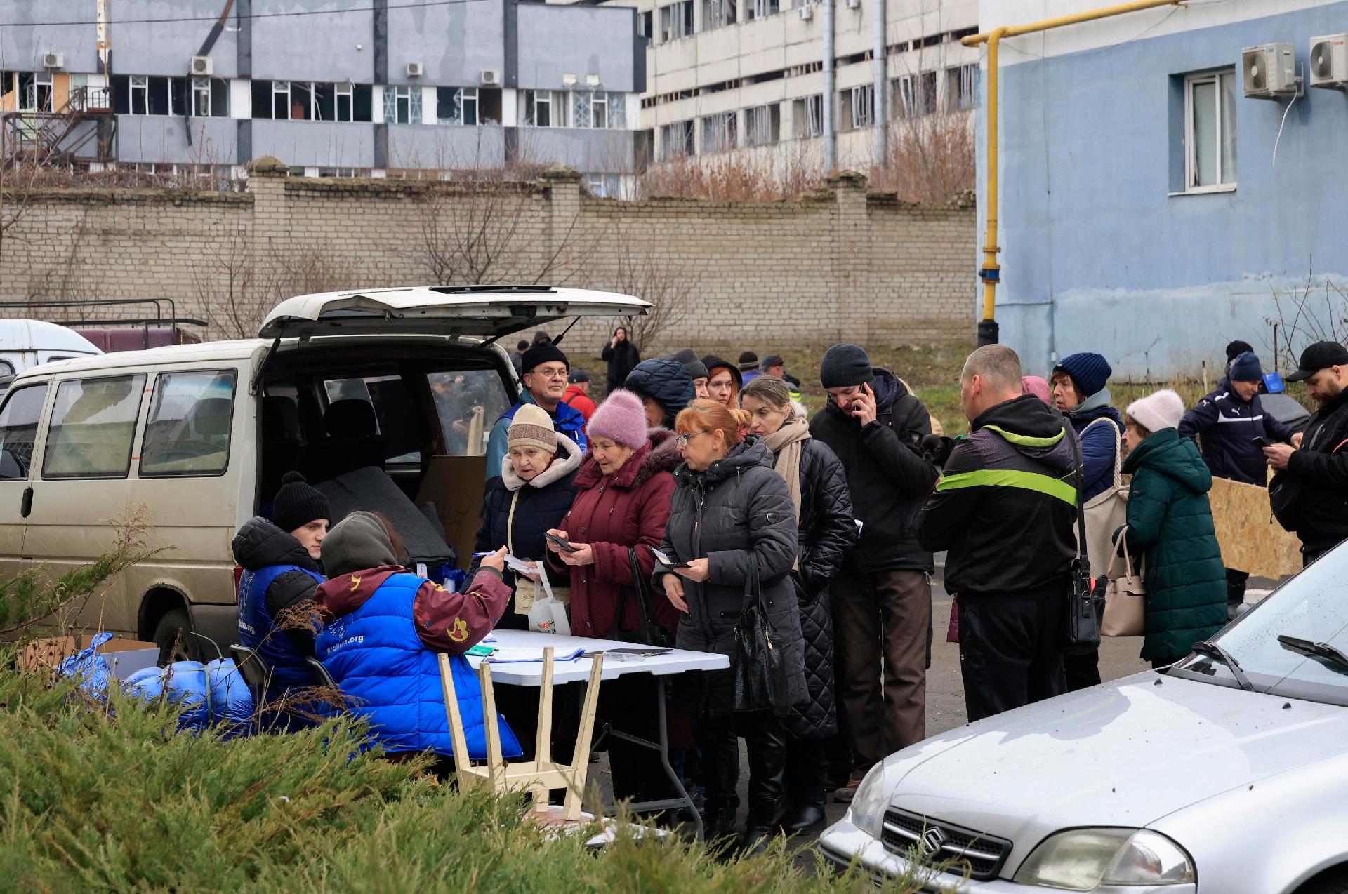 Moradores fazem fila esperando por ajuda perto de um prédio residencial danificado após um ataque de míssil em Kharkiv, nordeste da Ucrânia, 25 de dezembro de 2024, em meio à invasão russa. De acordo com o Serviço de Emergência Estatal da Ucrânia (SESU), pelo menos seis pessoas ficaram feridas na cidade de Kharkiv, nordeste da Ucrânia, depois que a Rússia lançou um ataque de míssil e drone em toda a Ucrânia em 25 de dezembro. EPA/SERGEY KOZLOV
