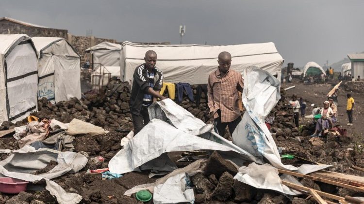 People dismantle tents to salvage materials in a refugee camp in Bulengo, Democratic Republic of Congo, 11 February 2025.